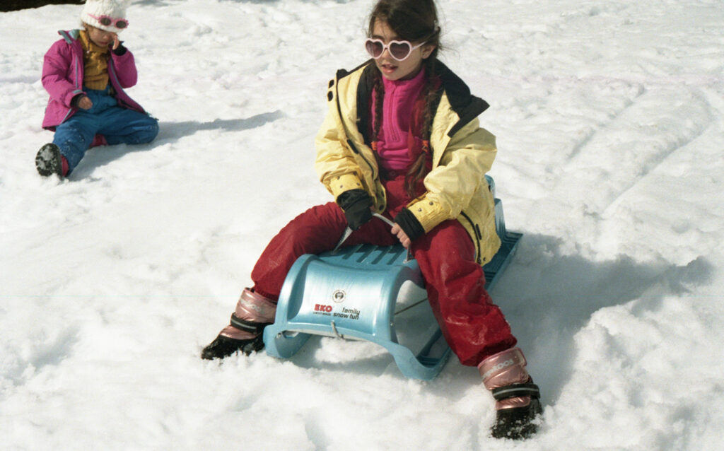 petite fille sur une luge dans la neige